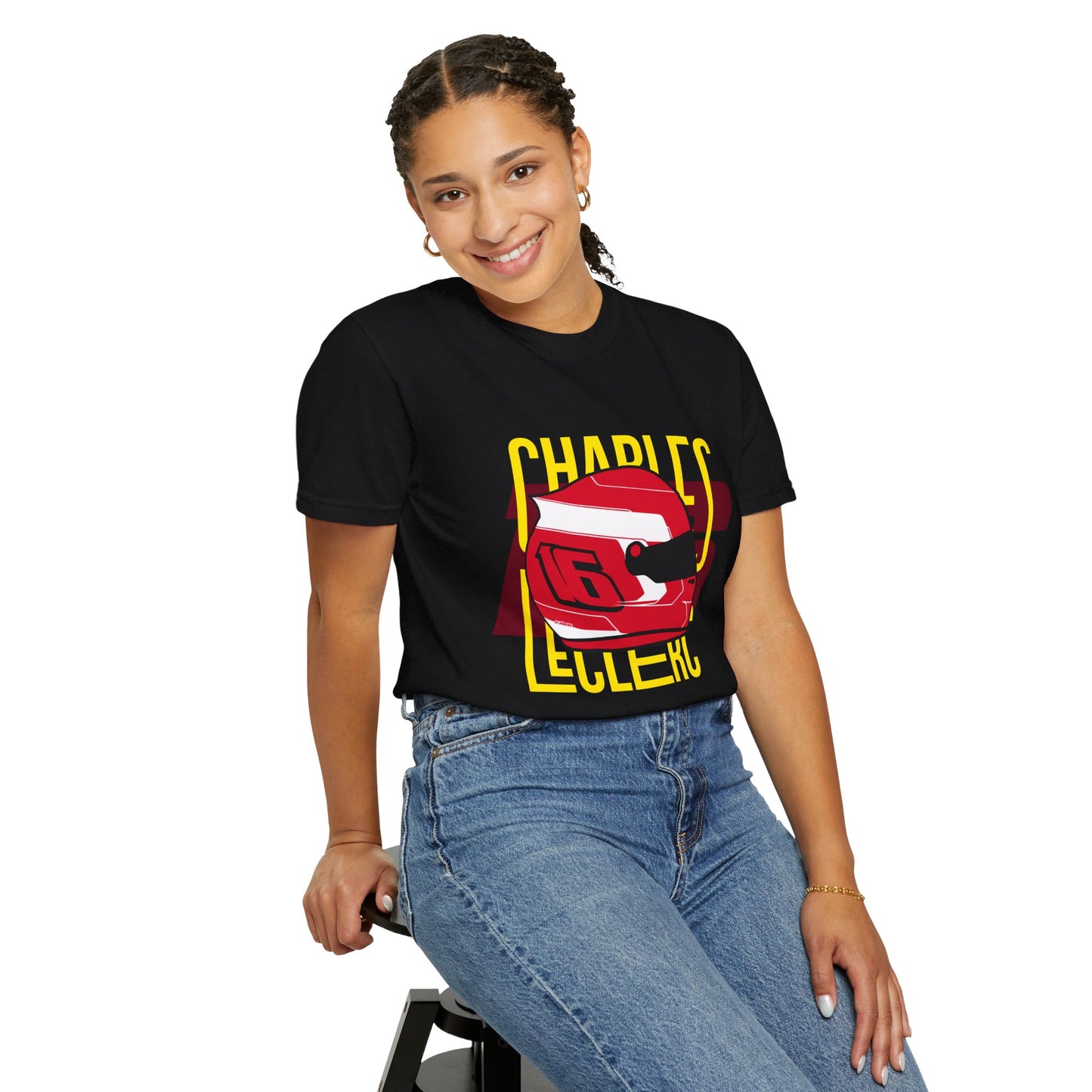 Female model wearing black t-shirt of Charles LeClerc. The t-shirt bears his iconic racing helmet along with his racing number 16. LeClerc is a Formula 1 driver for the sport's most successful team, Scuderia Ferrari. Charles LeClerc has more than 30 pole positions and 6 race wins. Buy this t-shirt now and show your love for Charles LeClerc.