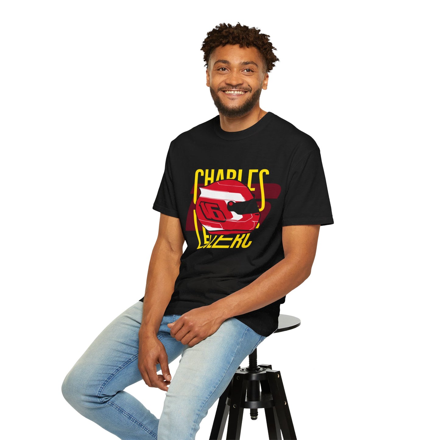 Male model wearing black t-shirt of Charles LeClerc, while sitting on a tool. The t-shirt bears his iconic racing helmet along with his racing number 16. LeClerc is a Formula 1 driver for the sport's most successful team, Scuderia Ferrari. Charles LeClerc has more than 30 pole positions and 6 race wins. Buy this t-shirt now and show your love for Charles LeClerc.